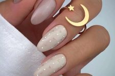 beautiful nude almond nails in various neutral shades, with two polka dot nails for an accent, are a super cool idea