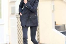 black skinnies, a black oversized short coat, red Mary Jane shoes and a black bag