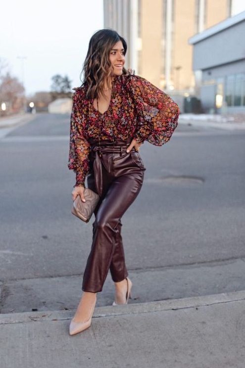 burgundy leather pants, a moody floral blouse, a small grey bag and blush shoes are a cool solution for a fall wedding guest