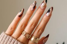 colorful swirl almond-shaped nails in black, burgundy and gold glitter are fantastic for fall or winter