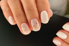 creamy and nude short square nails with touches of gold are amazing for a stylish spring or summer look
