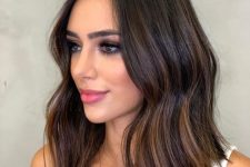 eye-catchy dark brunette wavy medium hair with copper and caramel balayage is adorable