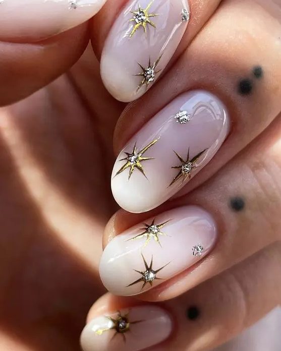 fantastic milky nails with gold stars with rhinestones are perfect for a celestial bride