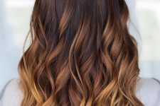 long dark brunette hair with an ombre effect to honey blonde, with waves and volume, is a chic and bold idea for anyone