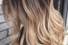 long ombre hair from dark brunette to bronde and bleached blonde, with volume and waves is a lovely solution