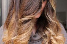long ombre hair from dark brunette to caramel and golden blonde, with volume and waves, is an amazing idea