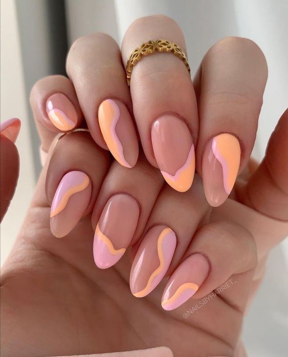 lovely and catchy almond-shaped nails with a touch of pink and Peach Fuzz done with an abstract design