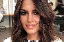 lovely layered dark brunette wavy shoulder-length hair with copper and caramel balayage