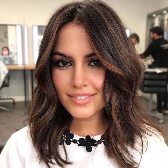 lovely layered dark brunette wavy shoulder-length hair with copper and caramel balayage