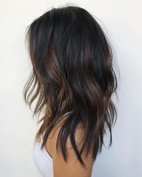 medium and layered dark brown, almost black hair, with copper balayage and messy texture is a bold solution