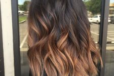 medium-length dark brunette to copper ombre hair, with a lot of volume and waves, looks absolutely adorable