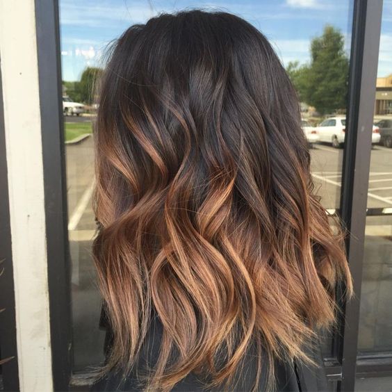 medium-length dark brunette to copper ombre hair, with a lot of volume and waves, looks absolutely adorable