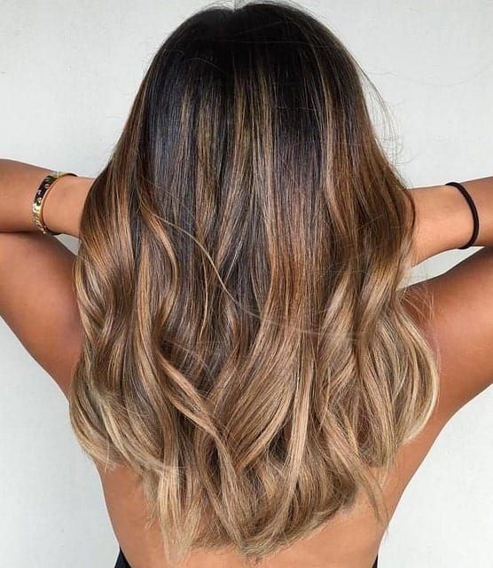 medium-length ombre hair from dark brown to bronde, with waves and a lot of volume, is adorable