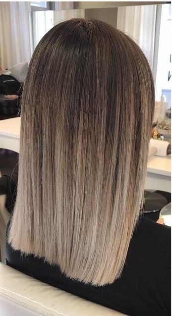 medium-length ombre hair from dark brunette to bleached blonde, with a lot of volume and texture is chic