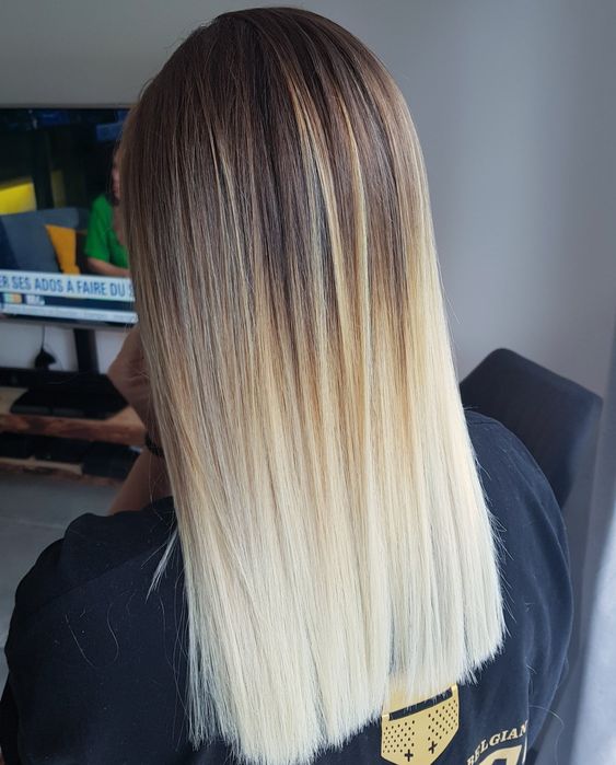 medium to long ombre hair from brunette to blonde and icy blonde, with a lot of volume