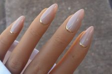nude almond-shaped nails with gold touches are a gorgeous idea if you love nude but need a fresh idea