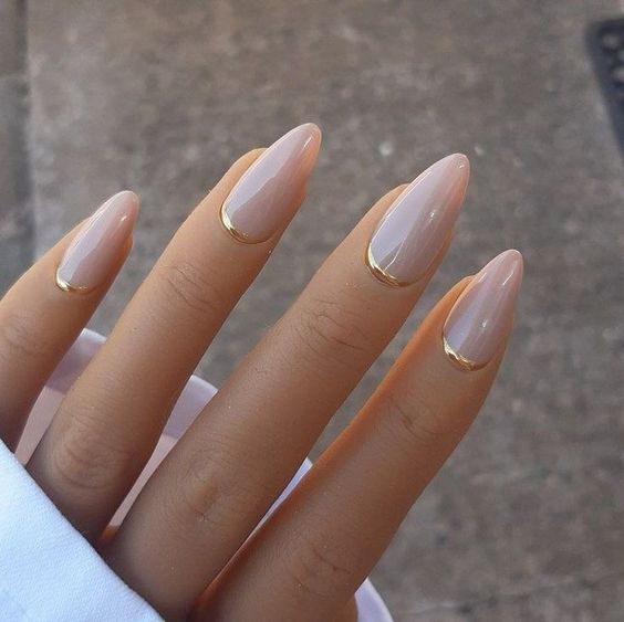 nude almond-shaped nails with gold touches are a gorgeous idea if you love nude but need a fresh idea