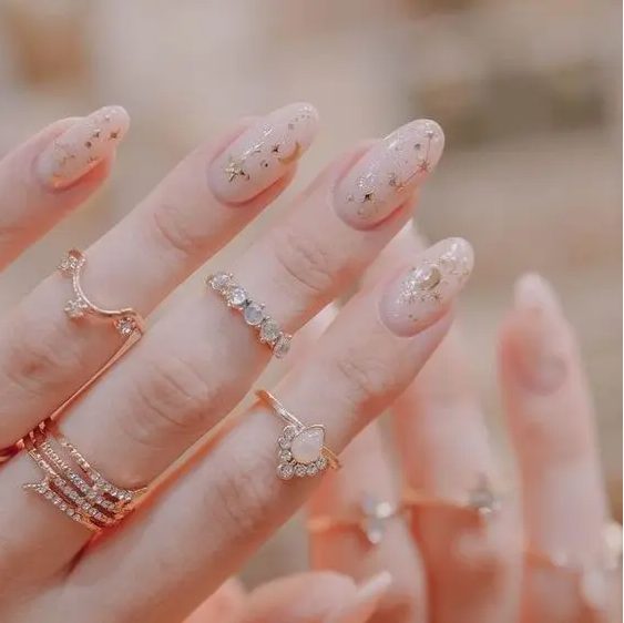 nude nails with constellations, stars and half moons are very beautiful and subtle, suitable for a celestial look