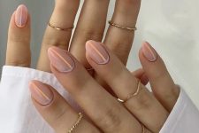 nude nails with vertical Peach Fuzz stripes and accents are a creative idea if you want something special