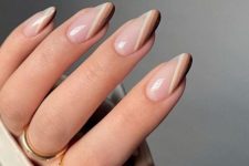 nude nails with white, tan and black stripes on one side are a cool solution, such design highlights the shape and length of the nails