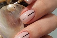 nude square nails with sliver glitter and black stripes are amazing for a super chic and glam look in any season