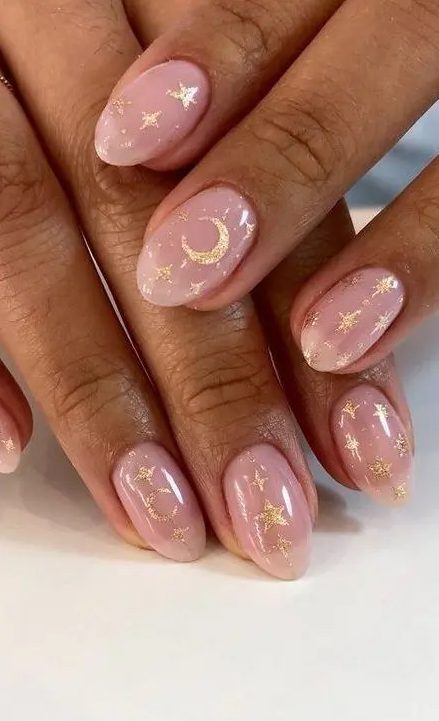 nude wedding nails accented with glitter stars and half moons are amazing for a celestial bride