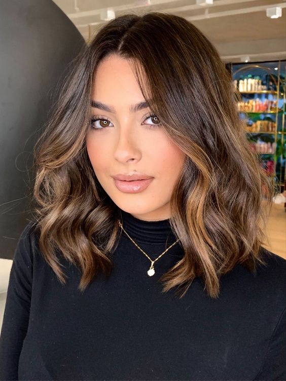 pretty dark brown shoulder-length hair with caramel balayage and waves is amazing