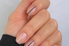 short nude square nails accented with black and white stripes are amazing for modern and minimalist looks