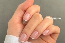 short square nude nails with white corners are a cool and fresh geometric version of French manicure