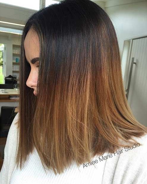 shoulder-length black hair with an ombre effect to copper and honey blonde, with a lot of volume, is a chic and catchy idea