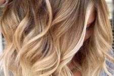 shoulder-length hair with an ombre effect from light brunette to bleached blonde and with waves