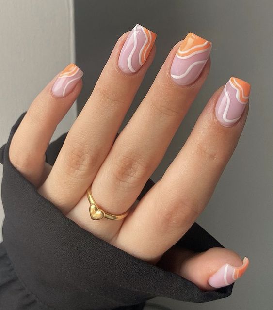 square-shaped nails with white and Peach Fuzz waves are a cool and catchy solution for peach tone lovers