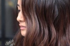 wavy and textural cold brew hair with burgundy touches and tips for a more dimensional and bold look