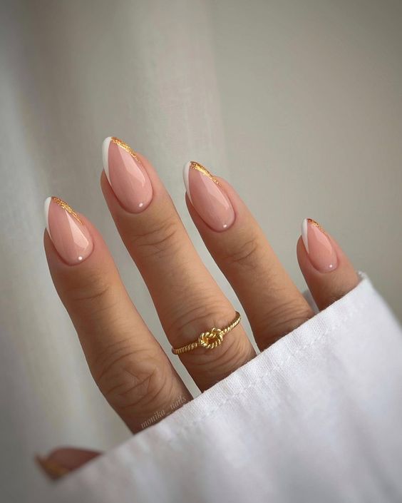 a beautiful French manicure version with narrow white and gold glitter tips is adorable for a spring wedding