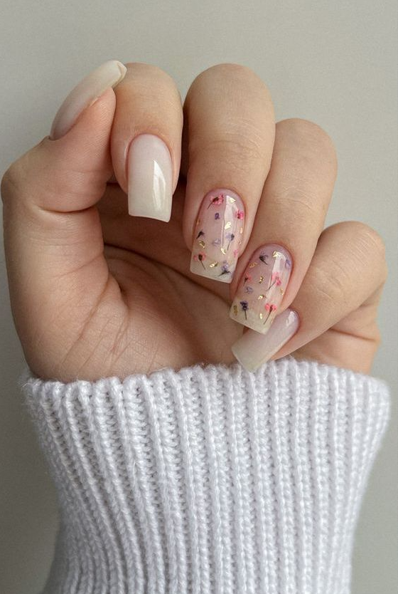 long milky nails accented with pink and purple dried blooms and gold leaf are amazing for a delicate spring look