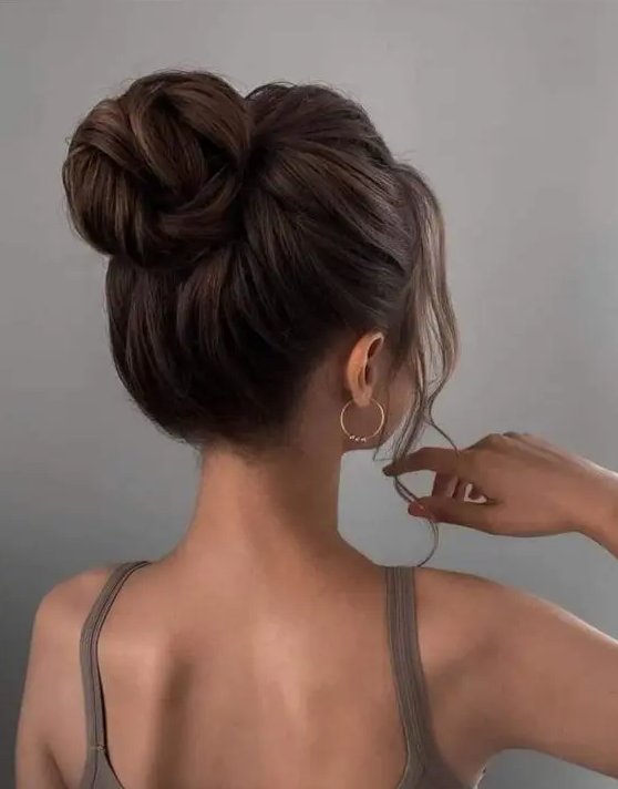 28 a classic twisted top knot with a bumpm on top and some locks down is a chic and catchy idea to try