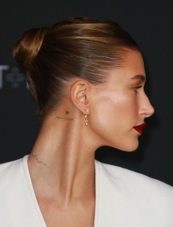 a minimalist wrapped top knot with a sleek top is a cool solution for any old money look
