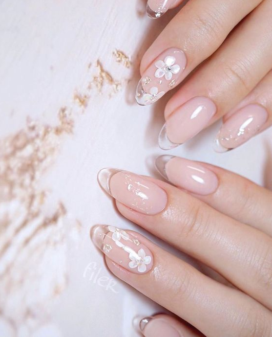 romantic nude nails with clear tips and accent floral nails with rhinestones are very chic