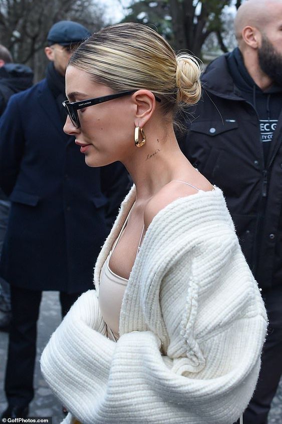 A sleek back midi bun is a timeless hairstyle that works for both medium length and long hair