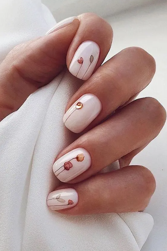 white nails with tiny and very delicate floral stickers are a fantastic idea for a spring or summer bride