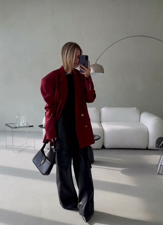 a black top, black trousers, an oversized cherry red blazer, black shoes and a black baguette bag for a bold look