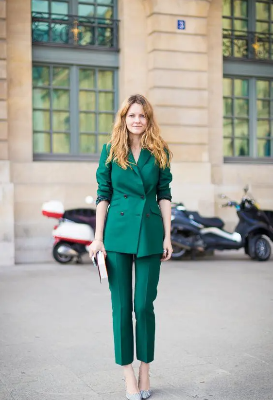 a bold emerald pantsuit with a double-sided jacket, cropped pants, metallic shoes and a clutch
