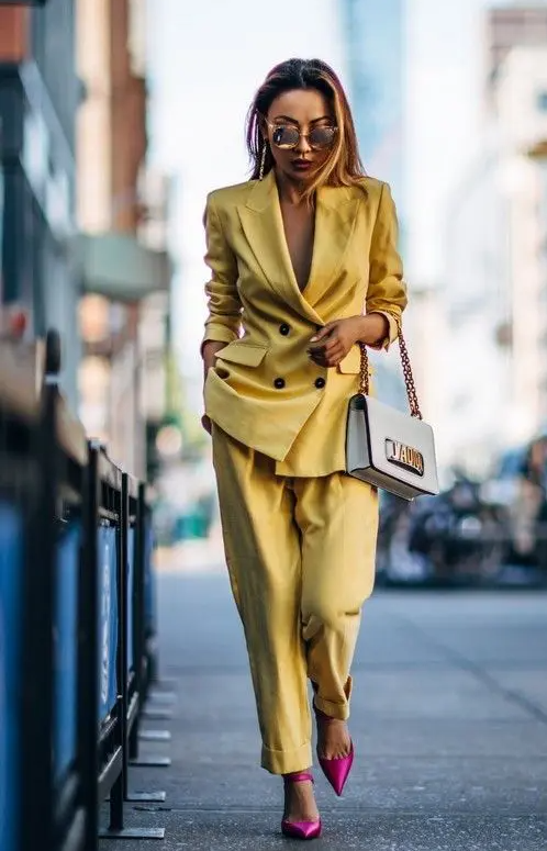 a bold yellow pantsuit with no top under and bold pink shoes for a special occasion