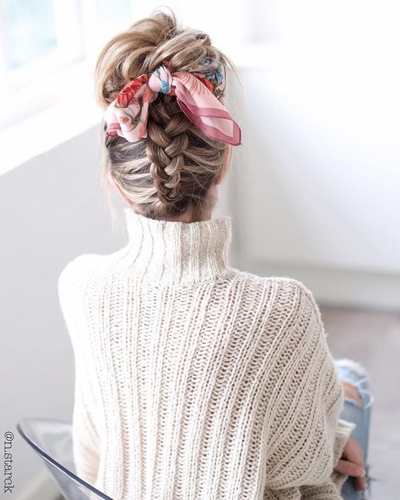a braided updo with some messy hair on top and a brigth printed scarf to accent the hairstyle is amazing