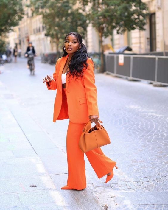 a bright look with an orange power suit, a white crop top, orange shoes and a bag is great for spring and summer