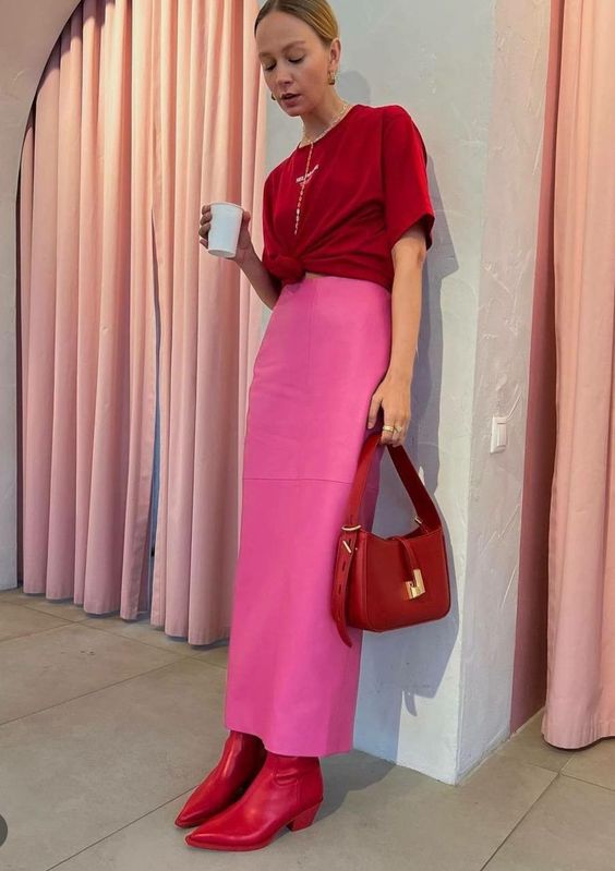 A cherry red knotted t shirt, a hot pink maxi skirt, red boots and a cherry red bag are a super bold solution