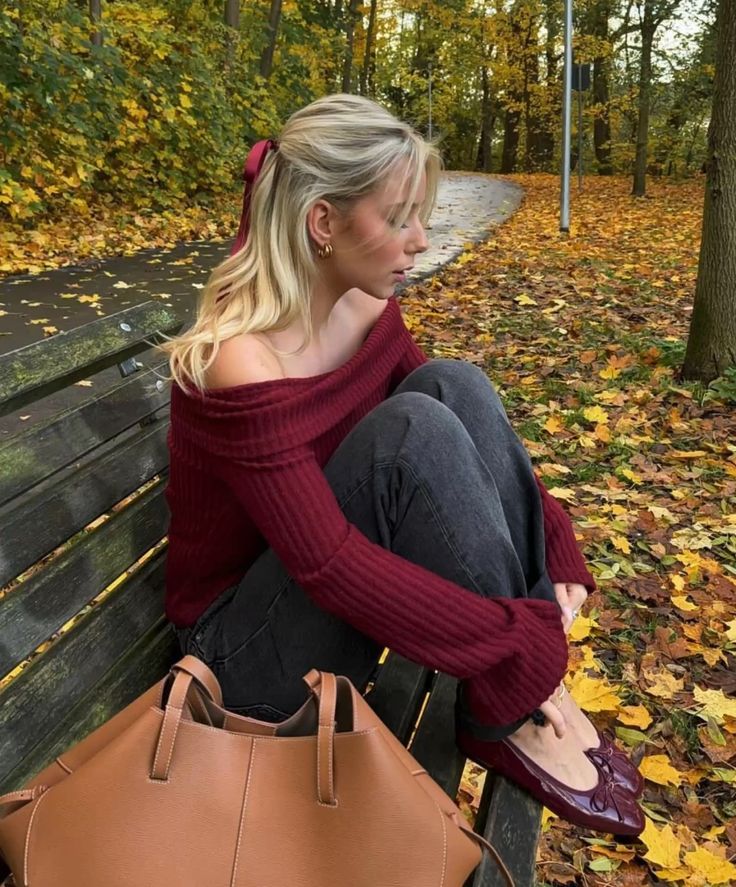 a cherry red off the shoulder sweater, grey jeans, burgundy flats and an amber leather tote for the fall
