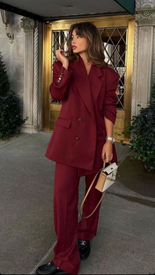 a cherry red oversized pantsuit, black loafers and a small white bag are a cool combo for an edgy look