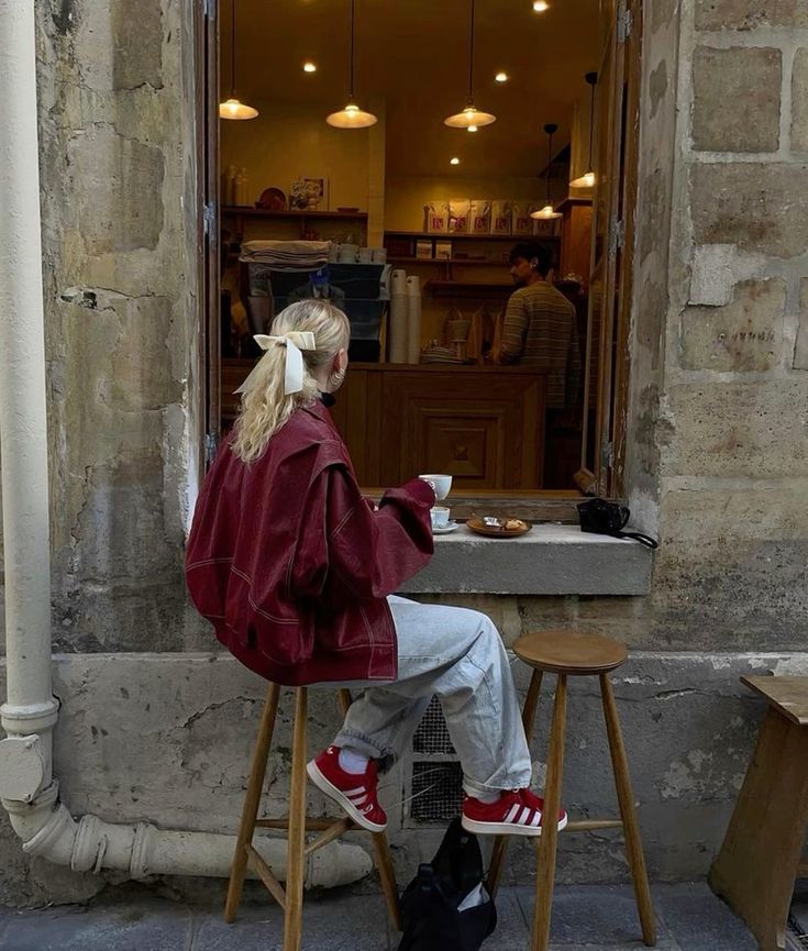 a chic look with a burgundy oversized jacket, bleached jeans, cherry red sneakers and white socks is cool