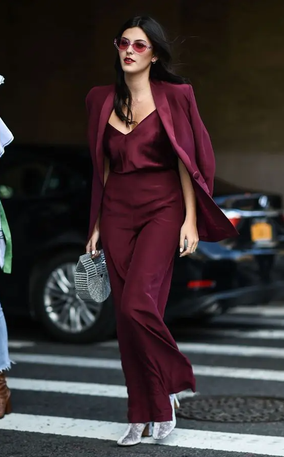 a chic party look with a burgundy top and pantsuit, silver boots and a silver bag is a bold idea to go for
